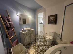 a bathroom with a sink and a toilet at El secret de la LLegenda El Cavaller in Vilavert +36 photos
