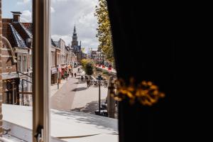 a view of a city street from a window at Stadsherberg de Wijnberg in Bolsward
