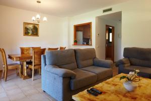 a living room with two couches and a table at Casas Golf Relax in Pals