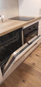 an oven with its door open in a kitchen at Apartament Roanta in Polanica-Zdrój +34 photos