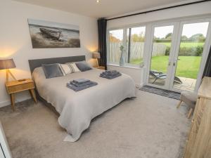 a bedroom with a bed and a large window at Low Tide Loft in Freshwater +43 photos