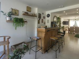 a bar in a living room with stools at Les Amandiers in Sallèles-dʼAude