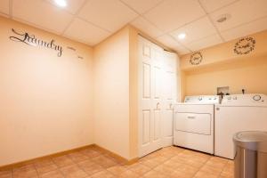 a laundry room with a washer and dryer at Charming Modern Farmhouse Retreat in Terre Haute +39 photos