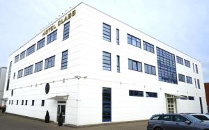 a white building with a sign on it at Hotel Class in Hamburg