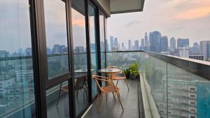 a balcony with two chairs and a table on a building at AYTE Capitol Suites - Central Jakarta City Centre in Jakarta