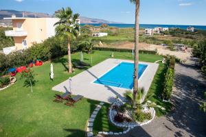 an aerial view of a yard with a swimming pool at Socrates Holidays Apt. 2 with Pool near the Beach in Plataniás