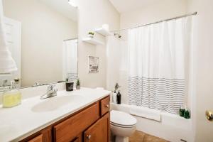 a bathroom with a sink and a toilet and a shower at The Clubhouse in Southern Pines +15 photos
