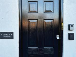 a black door with a sign in front of it at Stylish One Bedroom Apartment in Norwich