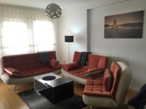 Sala de estar con 2 sofás y mesa en Apartment Royal, en Pristina