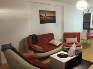 a living room with a couch and a table at Apartment Royal in Pristina