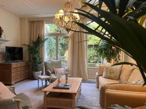 a living room with a couch and a table at Guesthouse Nights by Morpheus in Antwerp