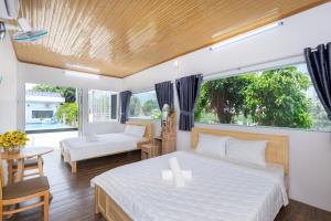 Ένα ή περισσότερα κρεβάτια σε δωμάτιο στο Lake Como Villa - View Bờ Hồ - Gần Cột Cờ Bãi Sau Thùy Vân