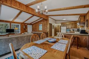 a kitchen and dining room with a wooden table and chairs at Mountain View Hideaway -- Pet Friendly, Grill, Wifi, Fire Pit, Deck, Screen Porch, Family Friendly, Game Room, Wood Stove in Morton Grove
