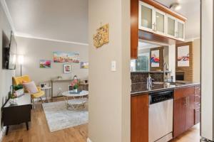 a kitchen and a living room with a table at Vibrant 2bed Condo - Stroll to SEA Space Needle in Seattle