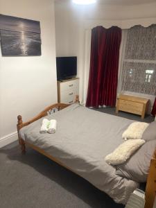 a bedroom with a bed with two towels on it at Fir Trees in Blackpool