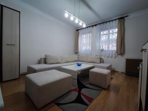 a living room with a couch and a table at CityCenter - Cozy, tiny house in the city center in Subotica
