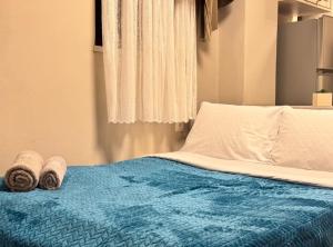 a bedroom with a bed with towels on it at Bloom Garden 1 in Mytilene