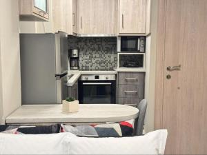 a small kitchen with a table and a counter top at Bloom Garden 1 in Mytilene