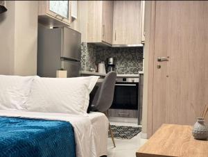 a bedroom with a bed and a kitchen at Bloom Garden 1 in Mytilene +18 photos