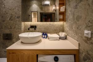 a bathroom with a sink and a mirror at Modular Central Studio in Kotor