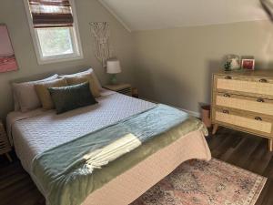 a bedroom with a bed with a dresser and a window at Perfect Lehigh Valley Oasis in Bethlehem