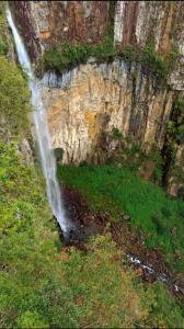 a waterfall on the side of a mountain with grass at Grandhouse Salto Donner in Rio Forcação