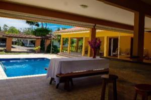 a patio with a table and a swimming pool at Grandhouse Salto Donner in Rio Forcação