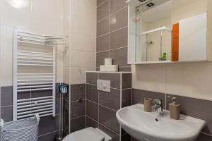 a bathroom with a sink and a toilet and a mirror at Flex SelfCheckIns 120 - Zagreb - Studio Apartment - Loggia in Zagreb