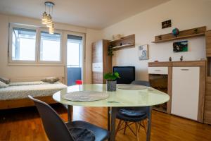 a living room with a table and chairs at Flex SelfCheckIns 120 - Zagreb - Studio Apartment - Loggia in Zagreb +21 photos
