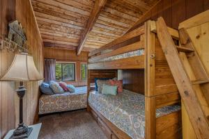 a bedroom with two bunk beds in a cabin at River Song Retreat - Right on the River! in Great Cacapon