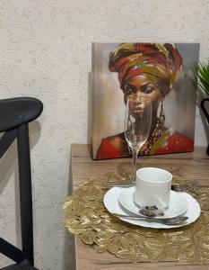 a painting of a black woman with a wine glass at Новая 1 комнатная квартира in Uralsk