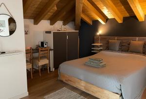 a bedroom with a large bed and a desk at Green Stay Bergamo in Bergamo