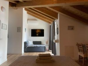 a bedroom with a bed and a tv on the wall at Green Stay Bergamo in Bergamo