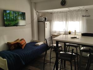 a kitchen and dining room with a couch and a table at AmaNi Tigre 2 in Bancalari