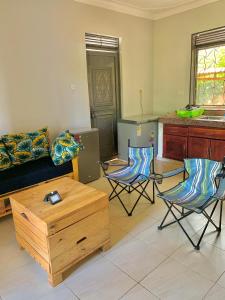 a living room with two chairs and a couch at WanderHome 1BDR - Jinja in Jinja
