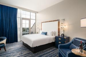 a hotel room with a bed and a couch at JW Marriott Savannah Plant Riverside District in Savannah
