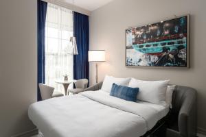 a hotel room with a bed and a couch at JW Marriott Savannah Plant Riverside District in Savannah
