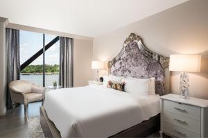 a bedroom with a large bed and a large window at JW Marriott Savannah Plant Riverside District in Savannah