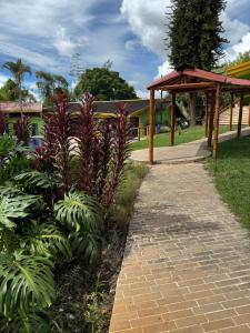 a path in a park with plants and a pavilion at Ecohotel La Casona Pereira in Pereira