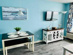 a dining room with a table and a mirror at Endless Ocean View Beachfront 1131 in Myrtle Beach