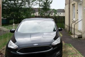 a car parked in a driveway next to a fence at 2-Bed Flat Wishaw Free Parking Family-Friendly in Wishaw