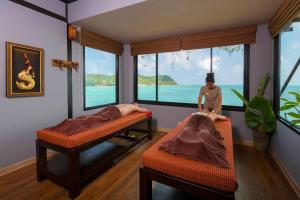 a room with two beds and a mannequin in the corner at Panviman Resort Koh Phangan - SHA Extra Plus in Thong Nai Pan Noi