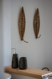 a wooden shelf with two candle holders on a wall at Sweet Cane Tiny House & Pool in Saint-François