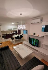 a living room with a couch and a table at Apartman Ada Milica in Železnička Stanica Incel
