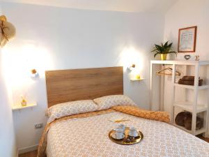a bedroom with a bed with a tray on it at Calin Apartment in Turin +30 photos