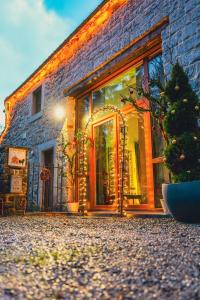 a building with a large glass door with a christmas tree at Gîte la casa del cookie in Chimay +59 photos
