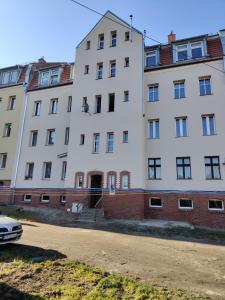 a large white building with a road in front of it at Gold Apartament in Wałbrzych