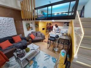 a woman standing in a kitchen in a living room at JP's Cityscape in Manila