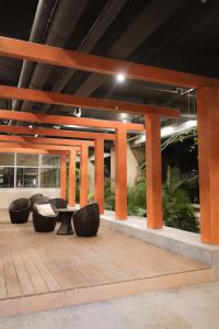 a group of chairs and tables on a wooden deck at JP's Cityscape in Manila
