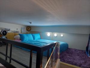 a bedroom with a bed with blue pillows at JP's Cityscape in Manila +32 photos